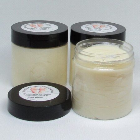 Golden Heel Foot Balm in a rustic jar surrounded by natural ingredients like kokum butter cocoa butter and essential oils