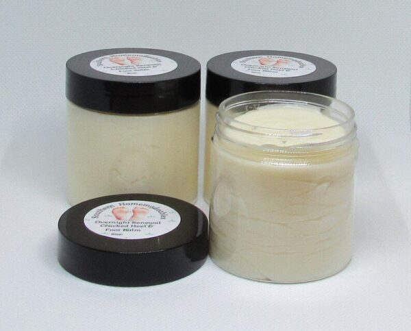 Golden Heel Foot Balm in a rustic jar surrounded by natural ingredients like kokum butter, cocoa butter, and essential oils.