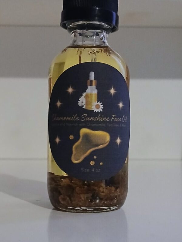 Chamomile Sunshine Face Oil in a glass bottle with chamomile flowers aloe vera and tea tree leaves on a wooden surface