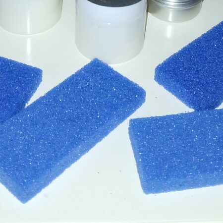 A disposable blue pumice pad for foot care, designed to gently remove rough skin and calluses. Perfect for home pedicures and single-use hygiene.