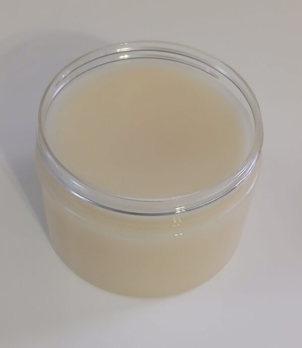 Golden Heel Foot Balm in a rustic jar surrounded by natural ingredients like kokum butter, cocoa butter, and essential oils.