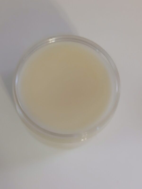 Golden Heel Foot Balm in a rustic jar surrounded by natural ingredients like kokum butter, cocoa butter, and essential oils.